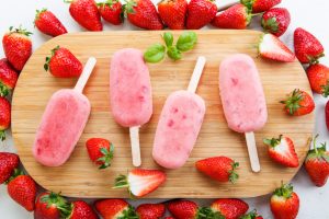 Homemade ice cream pops with fresh berries.